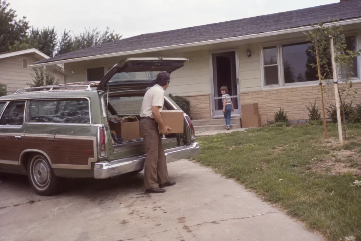A family standing outside their first house